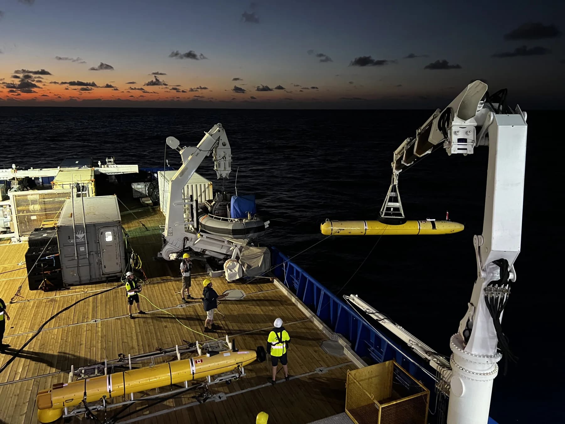 An autonomous underwater vehicle being launched at night