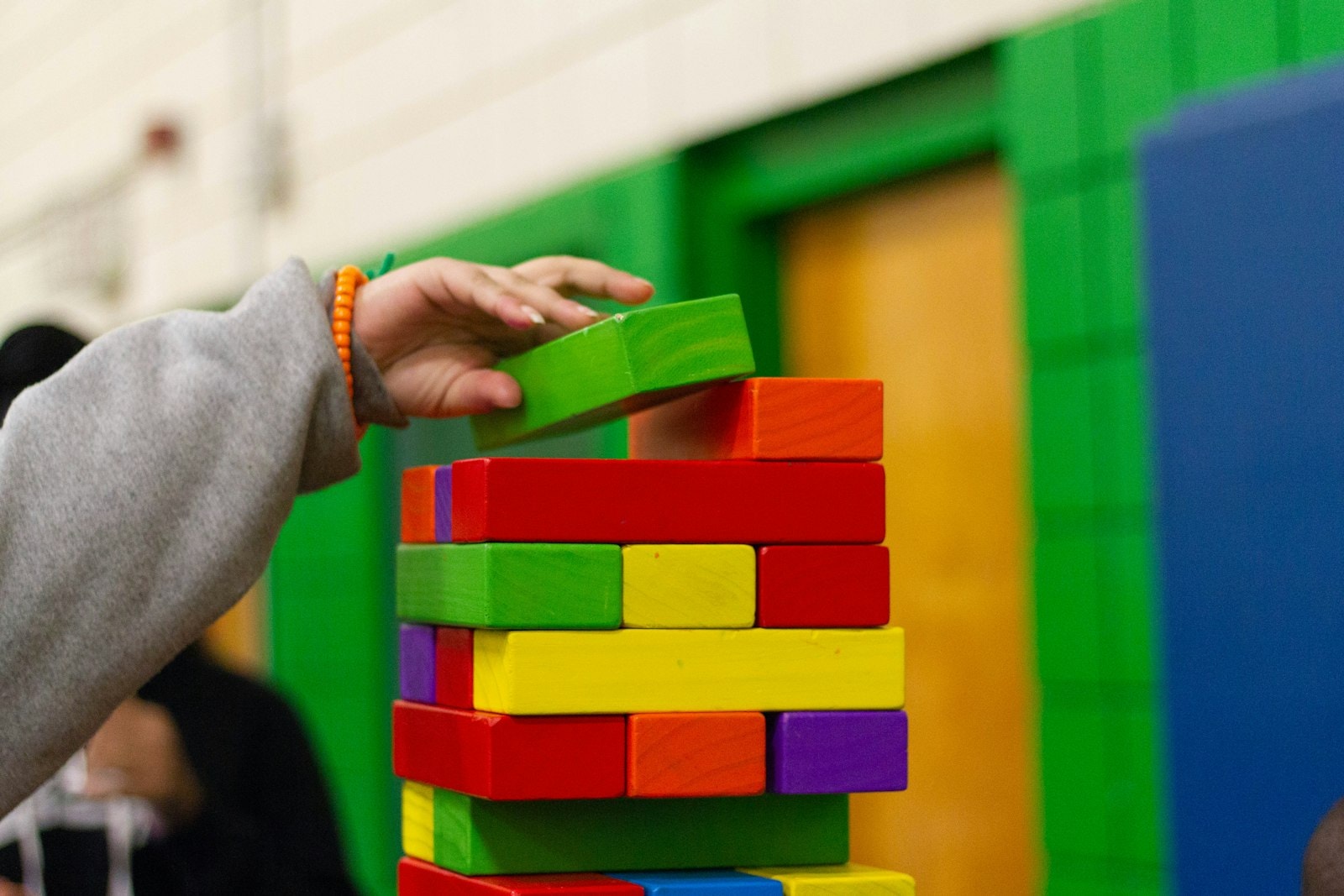 Person stacking wooden blocks